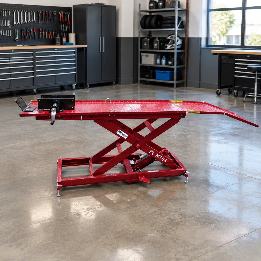 Mirage PL-MT06 pneumatic motorcycle lift parked empty in an organised dealership workshop bay.
