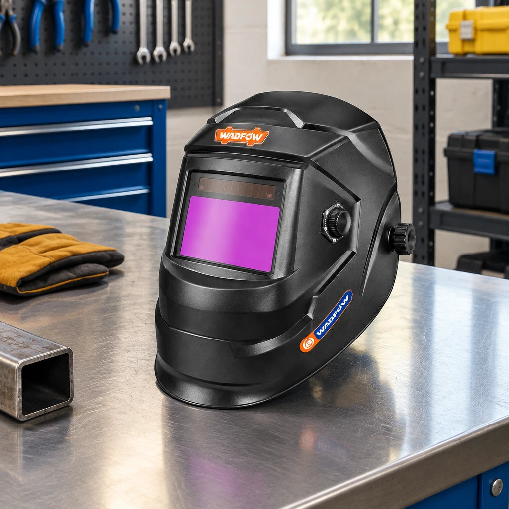 Wadfow auto-darkening welding helmet resting on a clean fabrication workshop bench beside organised PPE storage