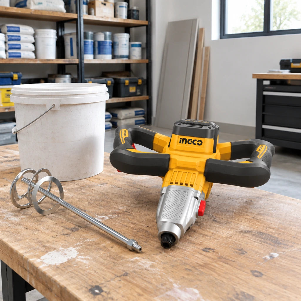Ingco MX516006 electric paint and mortar mixer resting beside a material-preparation station in a clean renovation room