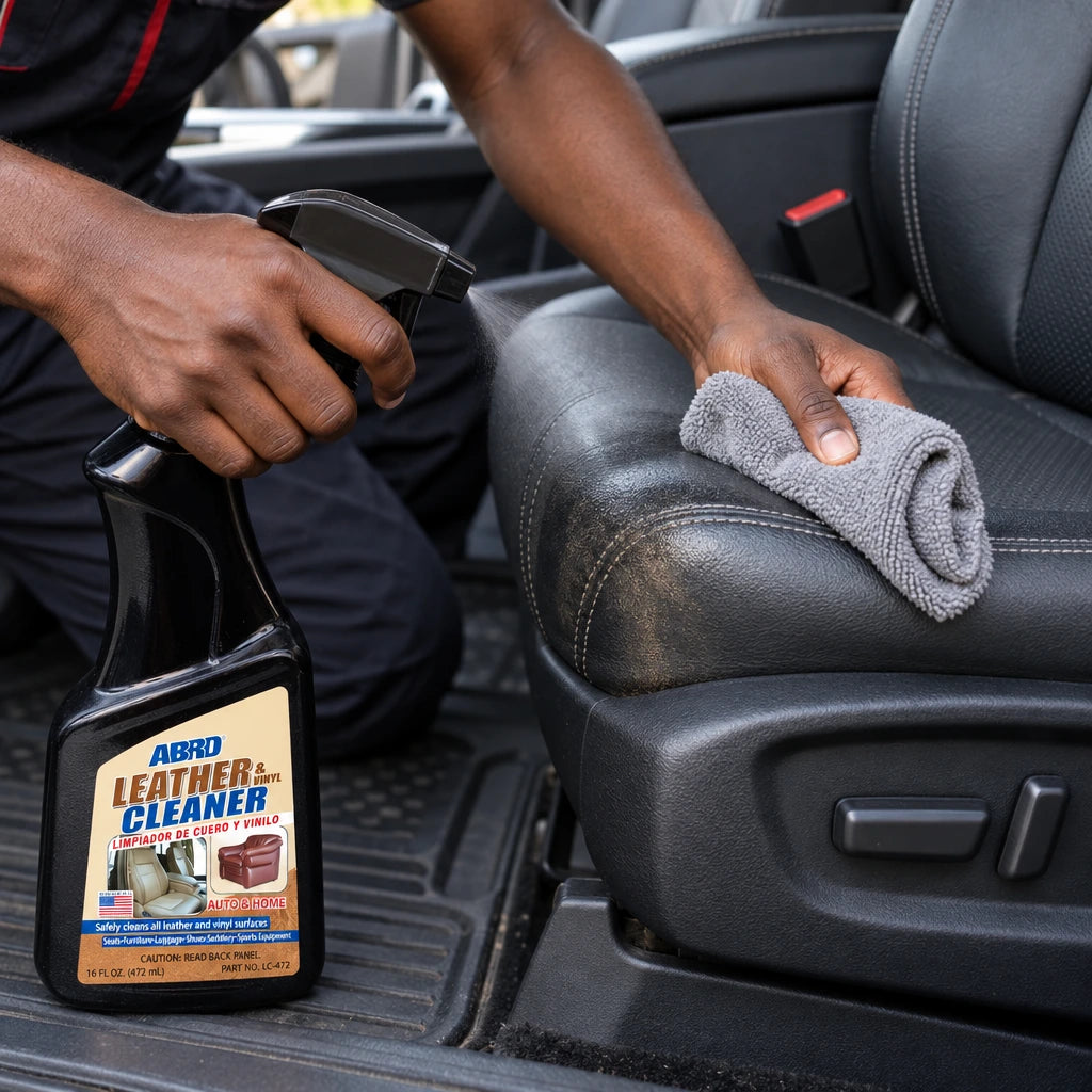 Ghanaian car detailer using Abro LC-472 leather and vinyl cleaner on a vehicle seat bolster