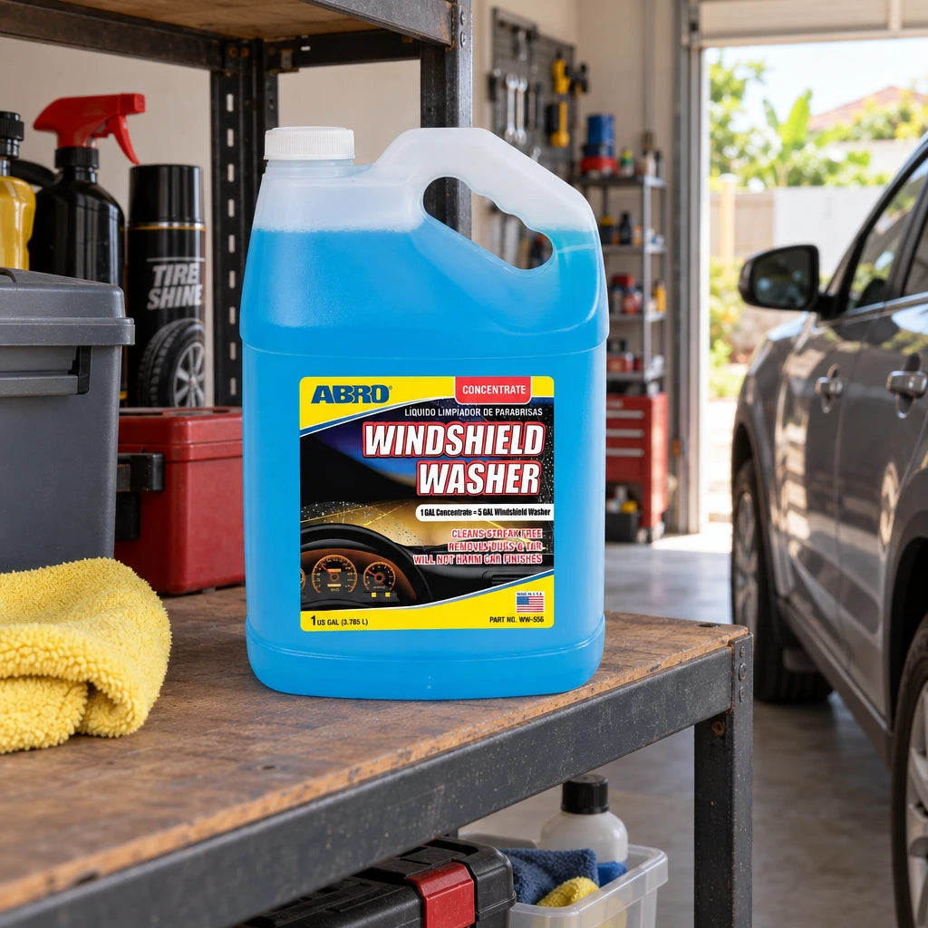 Abro windshield washer concentrate jug stored on a garage shelf beside a parked car