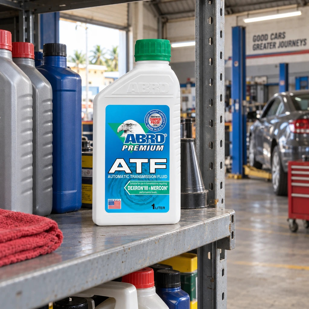 Capped Abro Premium ATF 1 litre bottle stored on a shelf in a Ghanaian auto repair workshop