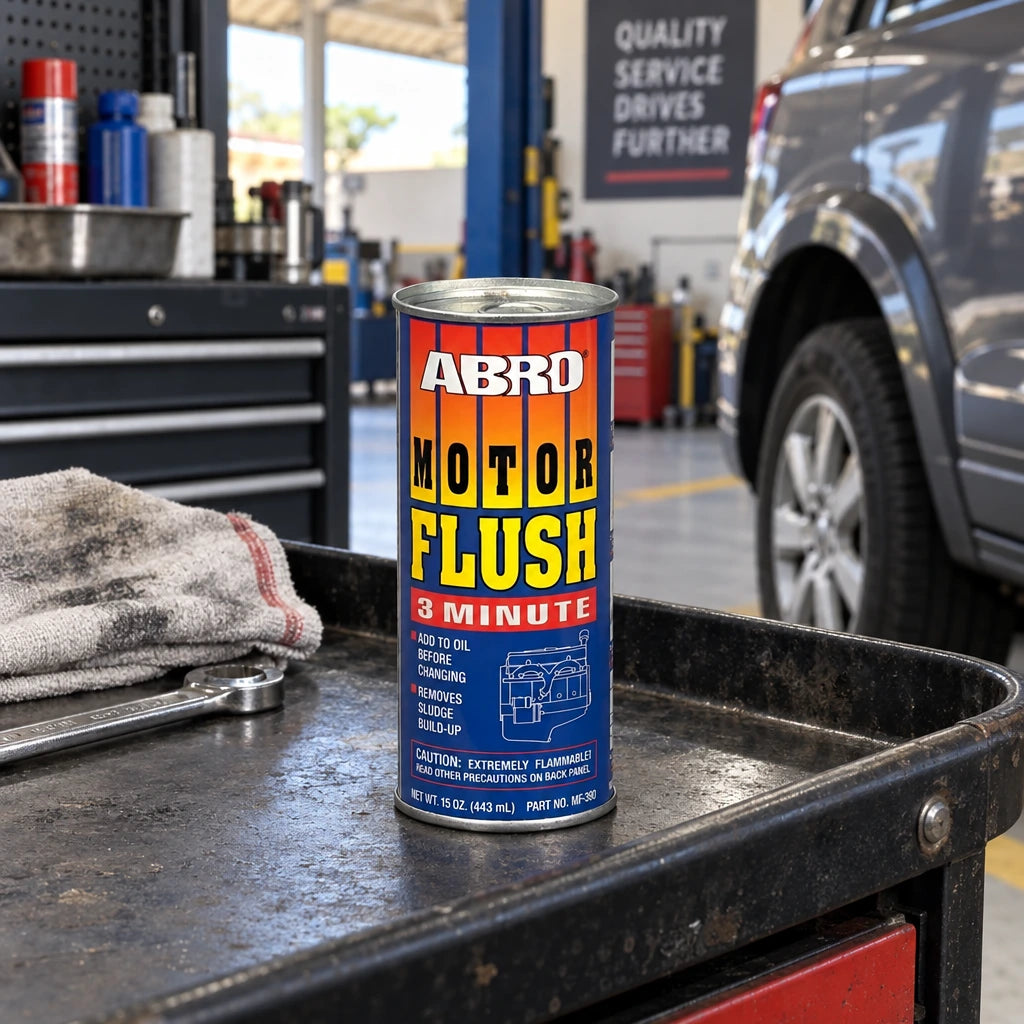 Unopened Abro MF-390 Motor Flush can resting on an automotive service trolley beside a parked vehicle
