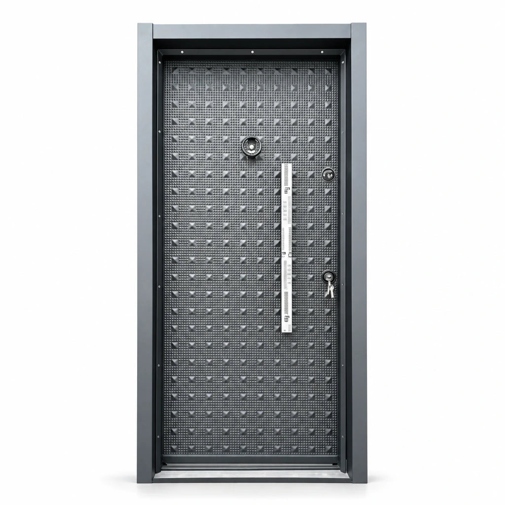 Graphite-grey Fort Door full-metal security entrance door with framed patterned panel, vertical handle plate and dual lock hardware on a white background.