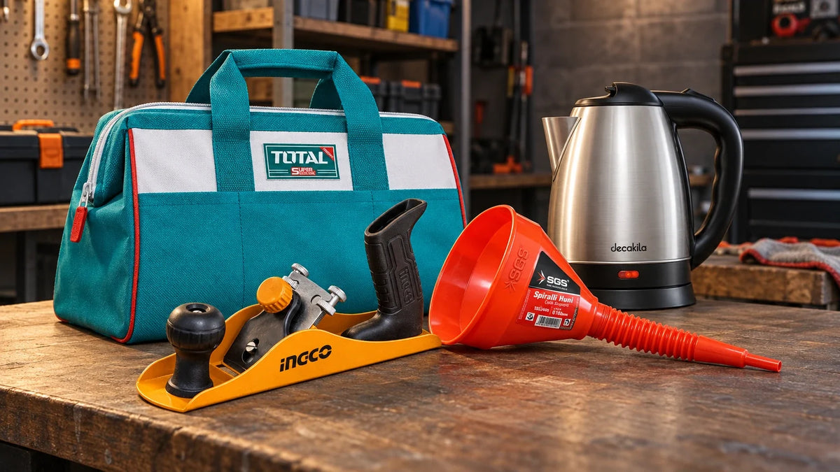 Affordable everyday utility products including a Decakila electric kettle, Ingco hand plane, Total tool bag and SGS automotive funnel arranged on a workshop ben