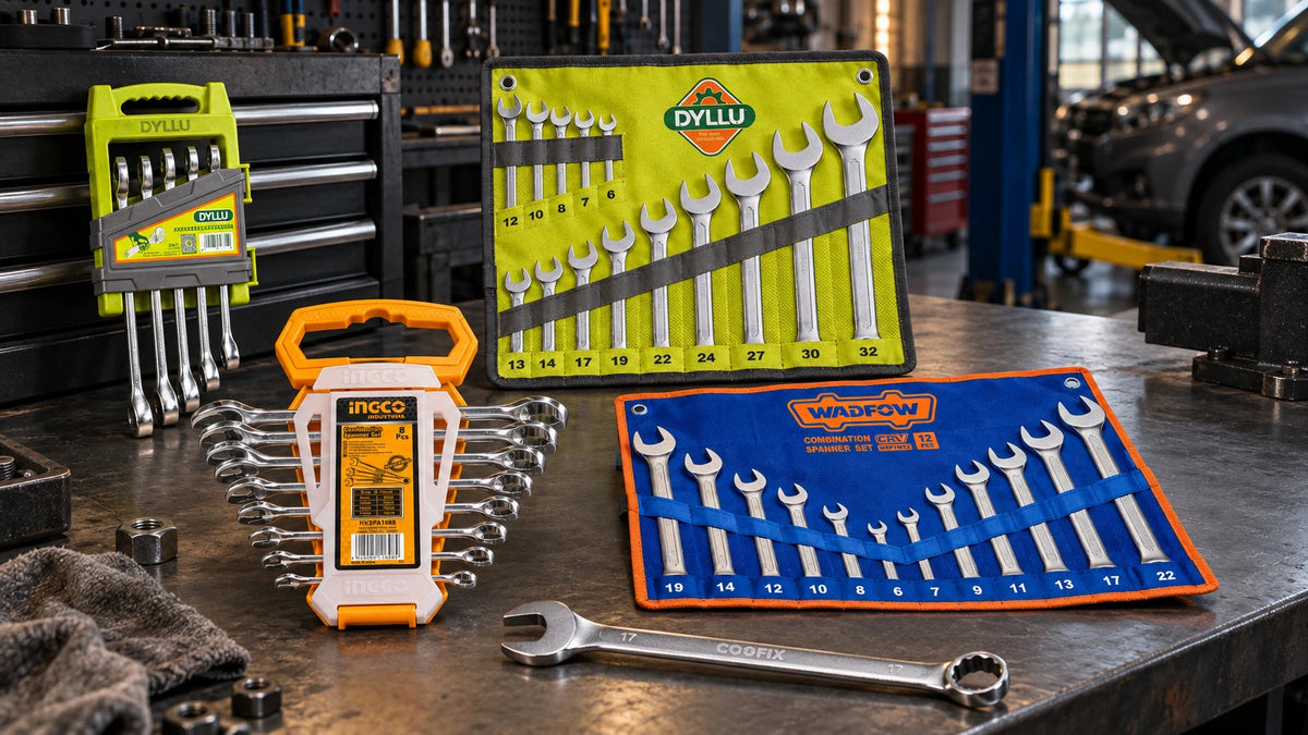 Five branded combination spanner sets and a standalone chrome-vanadium spanner arranged on a workshop bench, showing compact to 32mm metric tool coverage.