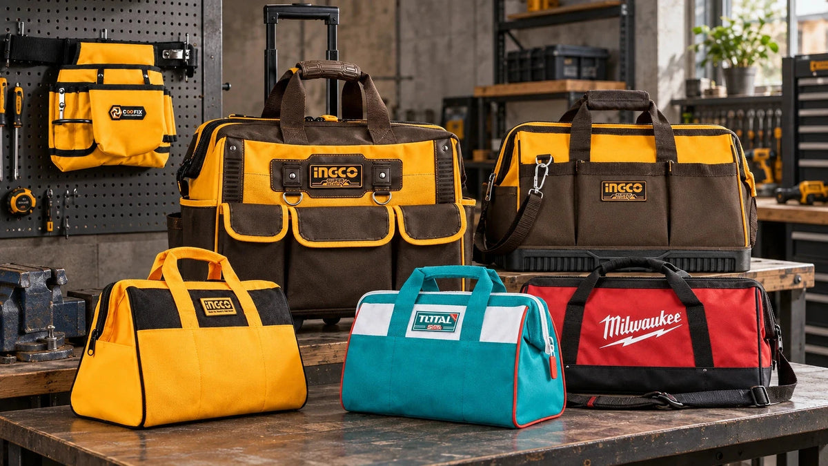 Six branded tool bags in different sizes and carrying styles arranged on a professional workshop bench, including rolling, contractor, shoulder, compact and Co一