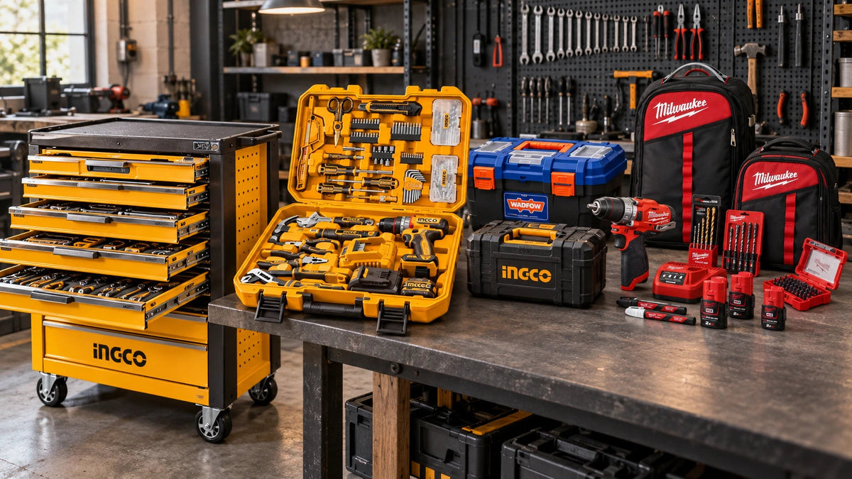 Professional power and hand tool sets arranged in an organised workshop, featuring an Ingco rolling tool chest, cordless drill kit, compact tool cases and red M