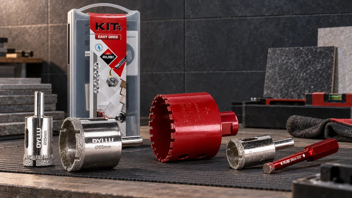 Diamond drill bit collection with Dyllu hole saws and Rubi wet and dry tile drilling tools arranged on a professional workshop bench