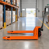 Atlas orange manual pallet truck parked with lowered forks in an organised retail distribution backroom