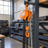 Atlas manual chain block stored in an organised metal fabrication workshop beside a designated lifting bay.