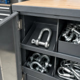 Atlas D shackle resting in an organised trailer-maintenance hardware cabinet