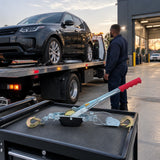 Recovered utility vehicle positioned for transport with the unloaded Atlas ratchet cable puller resting on a nearby equipment cart.