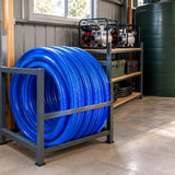Blue Berry PVC suction inlet hose coiled on a rack in an organised agricultural pump-storage shed