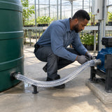 Irrigation technician securing Berry clear steel-reinforced PVC suction hose between a storage tank and transfer pump