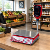 Camry 30kg digital price-computing scale resting on a clean grocery counter with its elevated display facing customers.