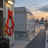 Completed commercial rooftop maintenance area with a red Climax CLI-28-N harness resting at the organised PPE station.