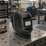 Climax 405-CPA welding helmet resting on an organised fabrication workbench before welding