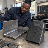 Completed steel repair beside a Climax 410-I handheld welding shield on a fabrication bench