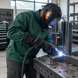 African American welder wearing a Climax 420 auto-darkening helmet while MIG welding a steel frame joint