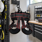 Climax Atlas fall-arrest harness hanging at an orderly professional PPE storage station