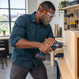 African American maker wearing Climax CLI-539 clear goggles while drilling a plywood panel
