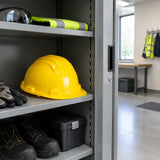 Yellow Climax 5-RS safety helmet resting in an organized commercial construction PPE cabinet