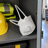 Climax valved FFP2 disposable respirator resting in a clean PPE storage compartment