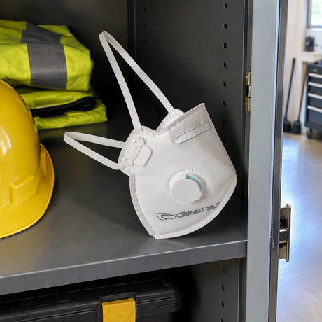 Climax valved FFP2 disposable respirator resting in a clean PPE storage compartment