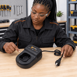 Black technician checking the Coofix 16 V charger before use