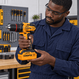 Black technician checking the Coofix battery beneath a cordless drill