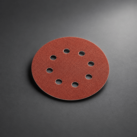 Eight-hole red sanding disc on a cinematic grey background