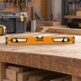 Coofix 60 cm magnetic spirit level resting on a joinery workshop bench before use