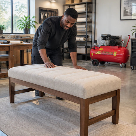 Finished upholstered bench ready for inspection with the GGA LT200S air compressor parked in a professional furniture studio.