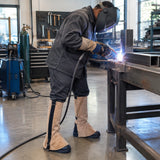 African American welder wearing Irona tan leather leggings while welding a steel repair component