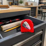 Closed red Kyoto 5M tape measure resting in an organised furniture workshop tool trolley