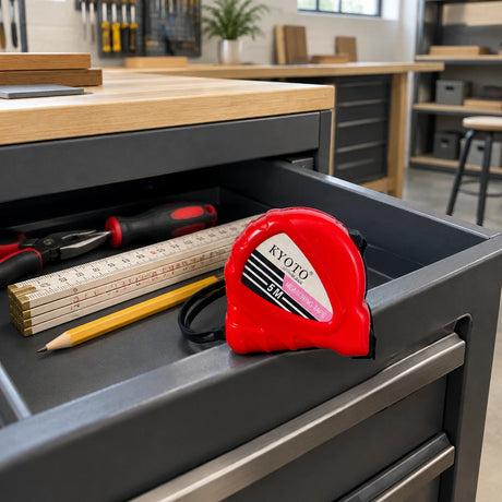 Closed red Kyoto 5M tape measure resting in an organised furniture workshop tool trolley