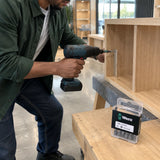 African American cabinet installer using a Wera PZ3 bit to fasten a Pozidriv screw into a retail display cabinet