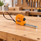 All-orange Coofix tape measure on a workbench
