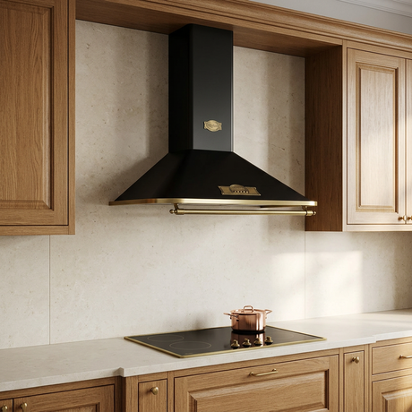 Black-and-brass cooker hood installed in a warm oak kitchen