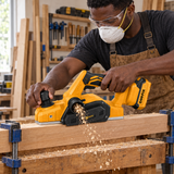 Black carpenter using the Coofix cordless wood planer