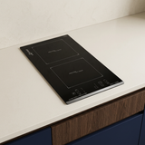 Black Domino induction hob installed in a walnut kitchen