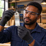 Black professional technician assessing the wide silver blade