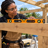Carpenter checking a timber beam with the Coofix spirit level