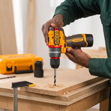 Carpenter drilling a clamped timber board with the Ingco cordless drill