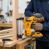 Carpenter positioning the Ingco brad nailer against clamped timber