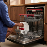 Close-up loading scene with the open Kaiser dishwasher