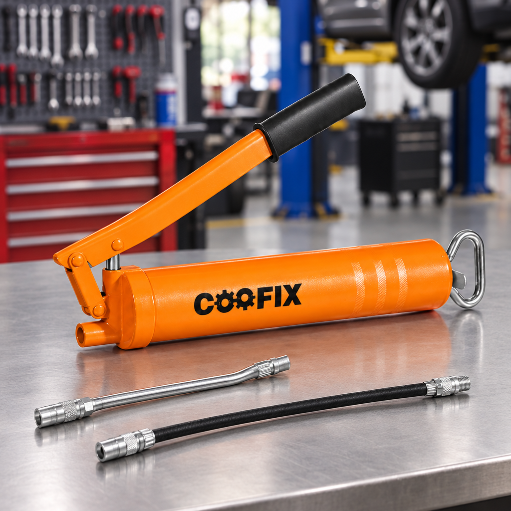 Coofix grease gun and nozzles on a workbench
