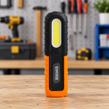 Coofix LED work light standing on a workbench