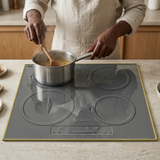 Face-hidden cooking scene using the gold-framed Kaiser induction hob